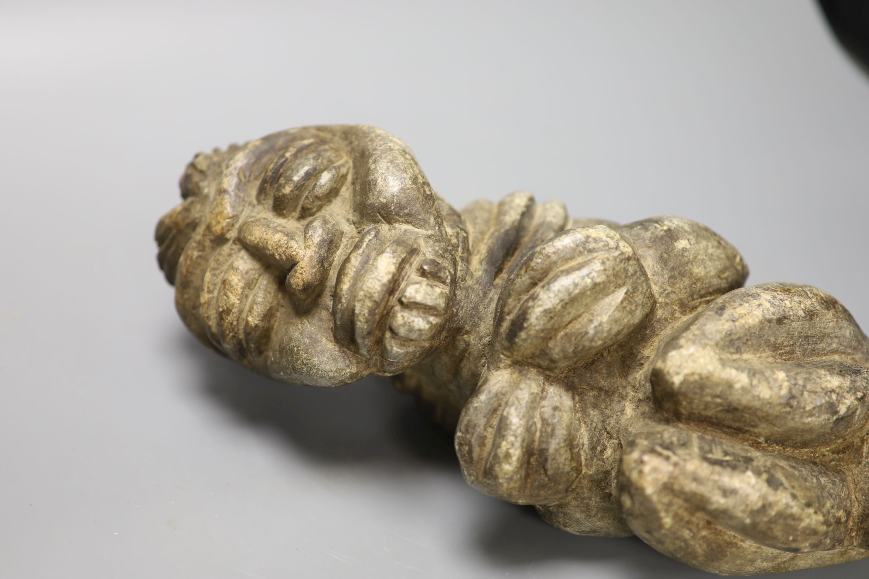 A South American carved stone figure, length 30cm